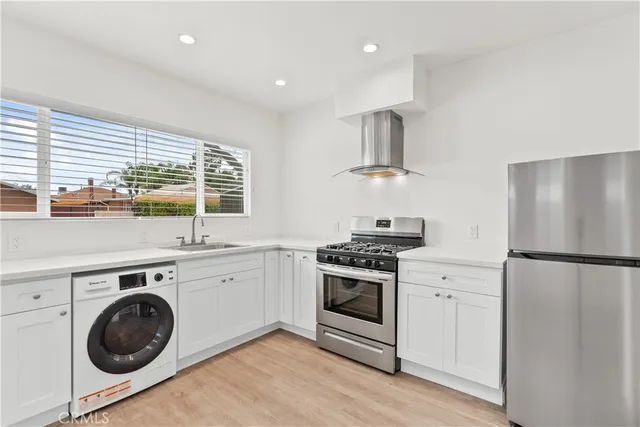 a kitchen with a stove top oven sink and refrigerator
