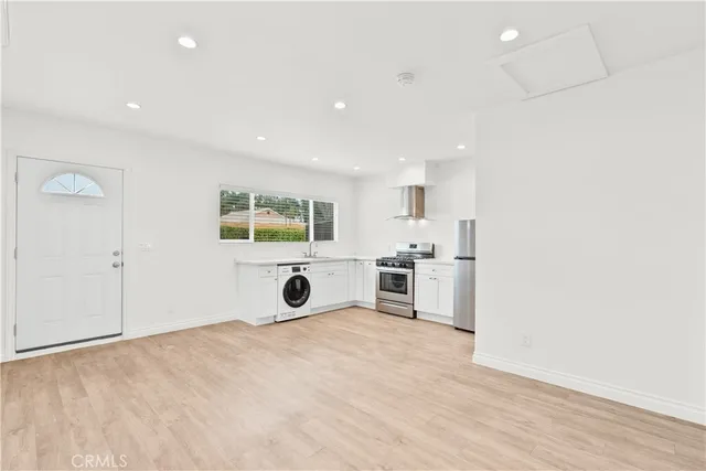 a view of a kitchen with a sink and a stove top oven