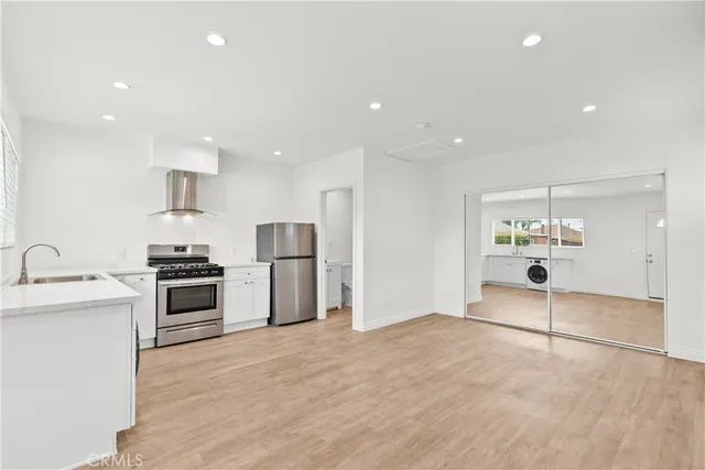 a kitchen with a sink and a stove top oven