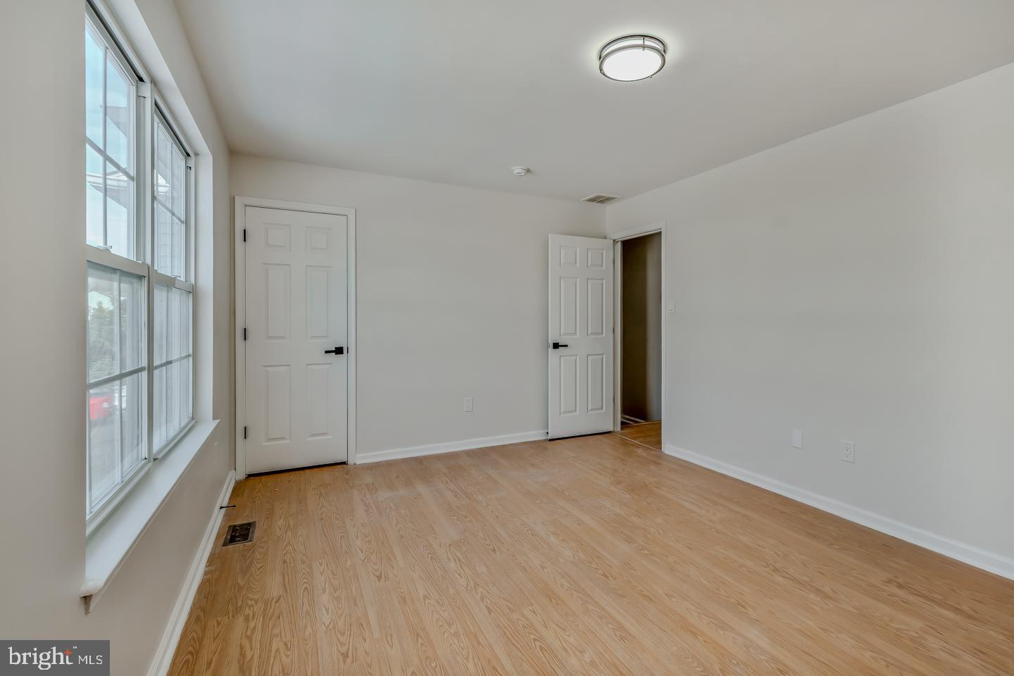 2704 Tall Pines Pine Hill, NJ 08021 - Photo 12 of 21 a view of an empty room with wooden floor and a window