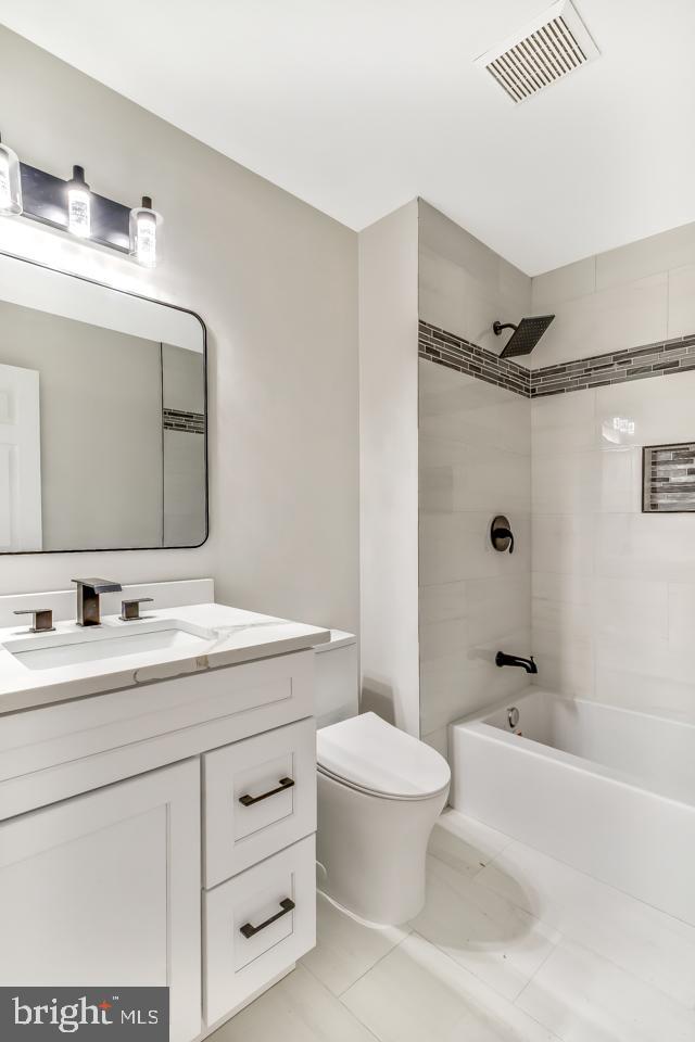 2704 Tall Pines Pine Hill, NJ 08021 - Photo 15 of 21 a bathroom with a toilet a sink a tub and mirror