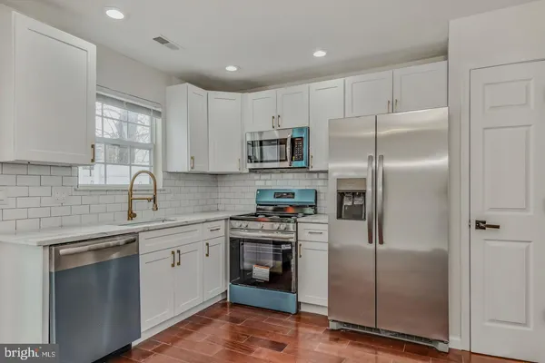 a kitchen with a refrigerator sink and microwave