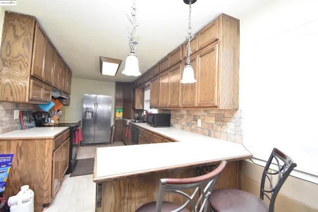 a kitchen with a table and chairs
