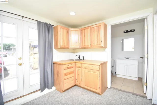 a spacious bathroom with a granite countertop sink mirror and a bathtub