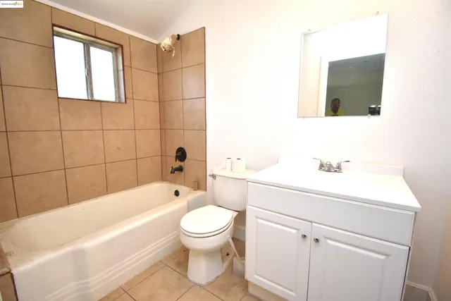 a bathroom with a toilet a sink a mirror and bathtub