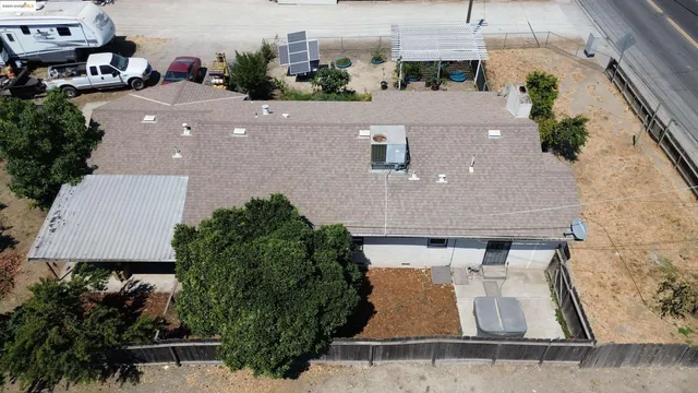 an aerial view of a house with yard