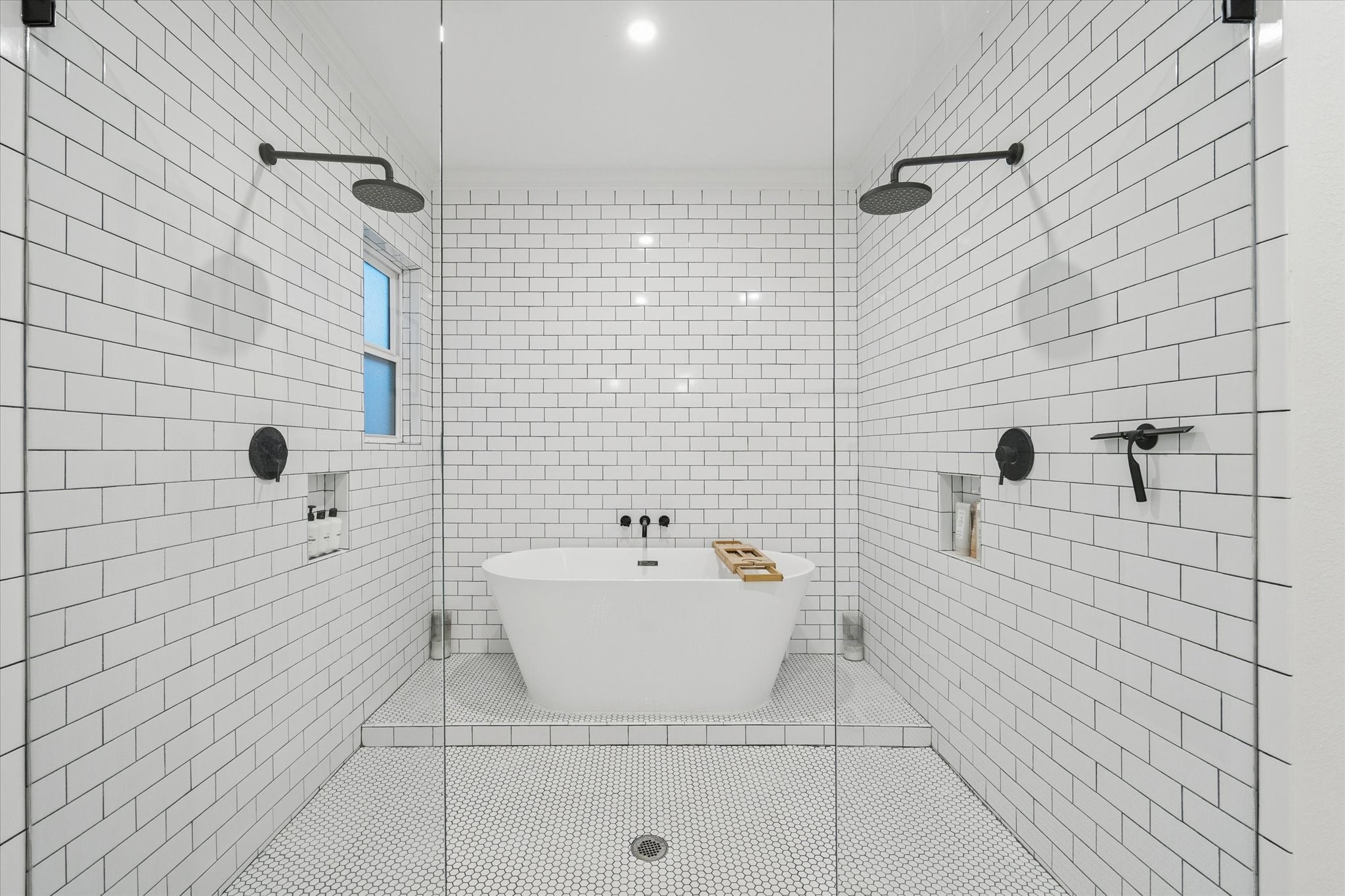 1135 Walling Street Houston, TX 77009 - Photo 14 of 32 primary bathroom, dual shower head, large soaking tub, subway tile, matte black hardware.