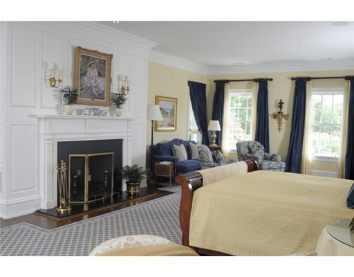 Undisclosed Address Greenwich, CT 06831 - Photo 9 of 10 a bedroom with a bed a fireplace and a large window