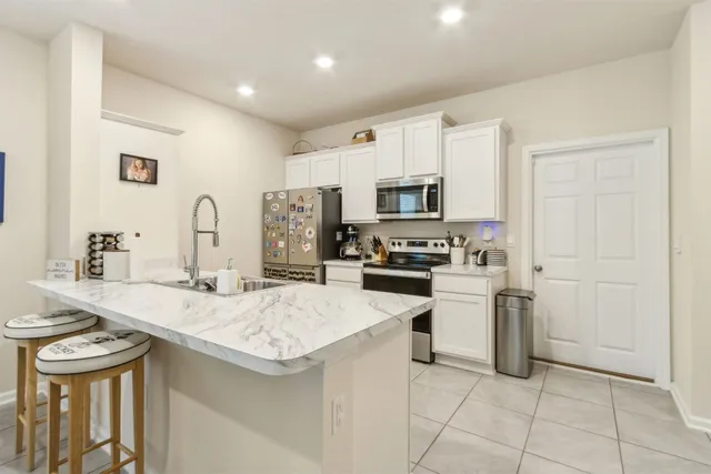 a kitchen with a sink appliances and cabinets