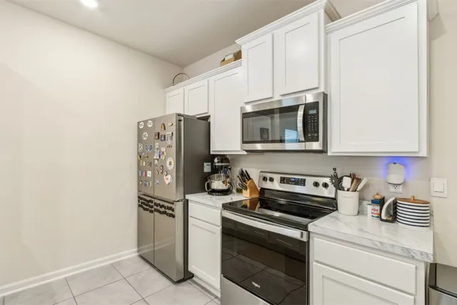 a kitchen with stainless steel appliances a refrigerator stove and microwave