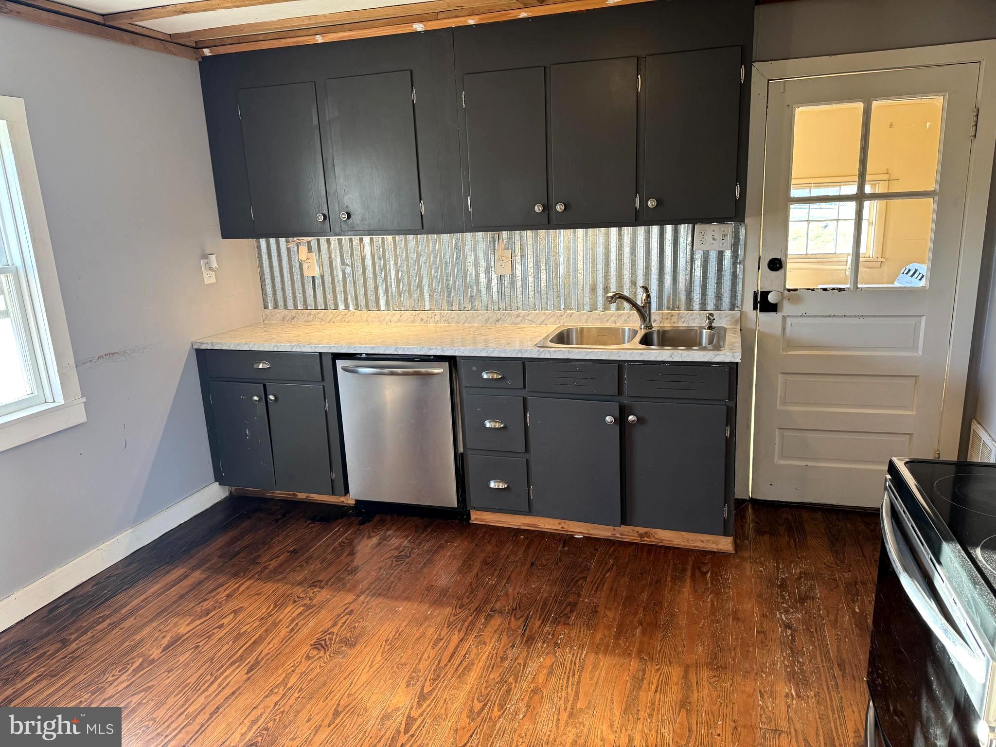 136 Shady Creek Road Clear Brook, VA 22624 - Photo 2 of 22 a kitchen with a sink and wooden cabinets