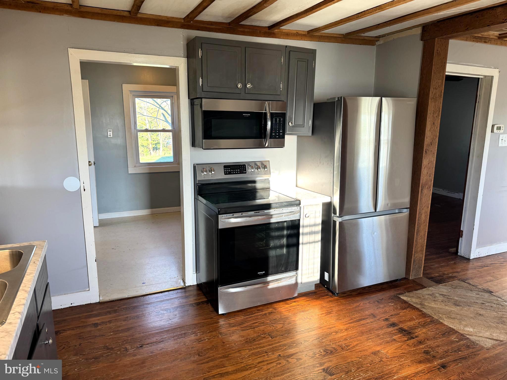 136 Shady Creek Road Clear Brook, VA 22624 - Photo 3 of 22 a kitchen with a refrigerator stove and wooden floor