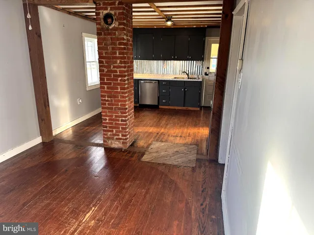a view of hallway with wooden floor