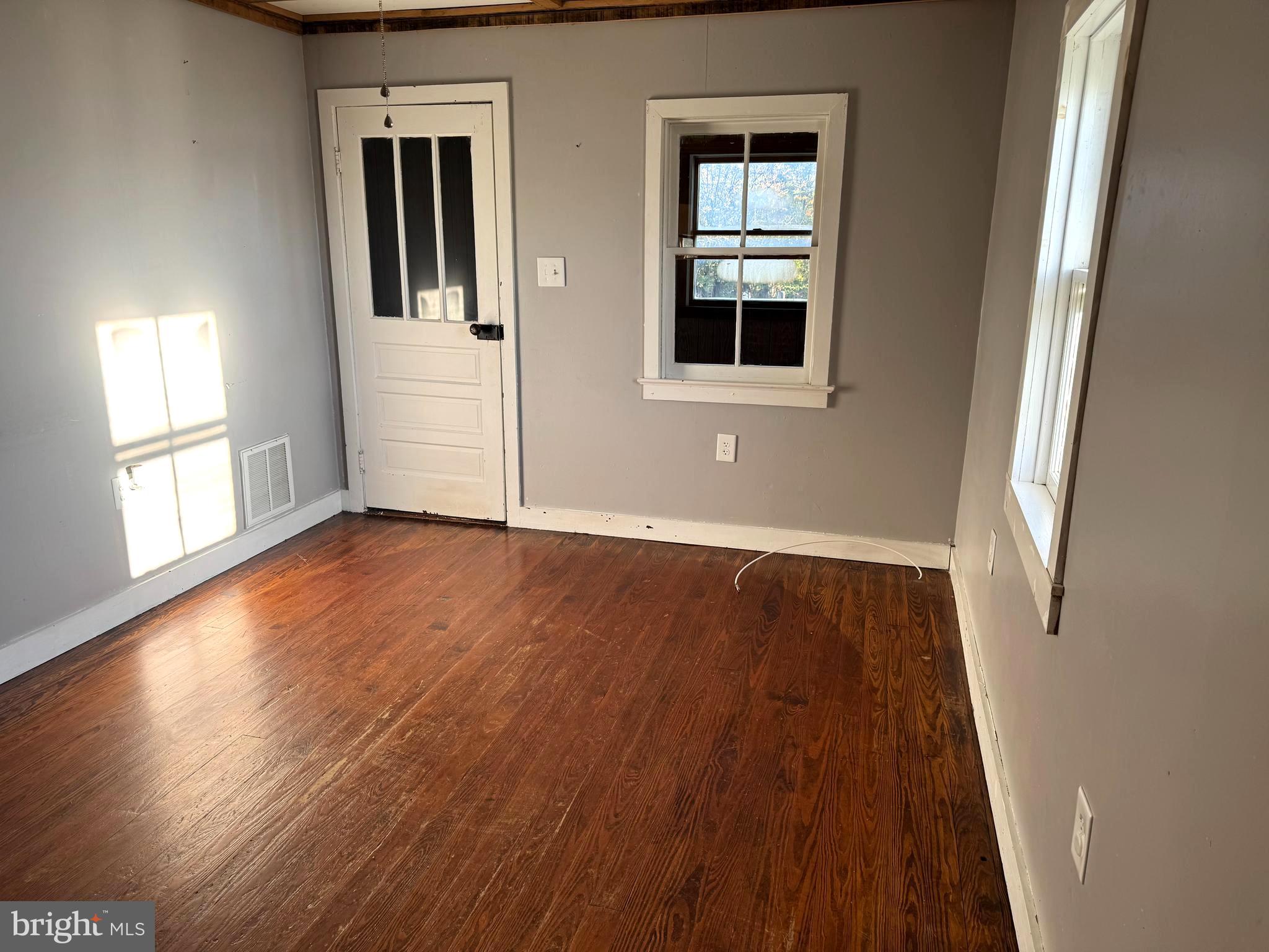 136 Shady Creek Road Clear Brook, VA 22624 - Photo 5 of 22 a view of an empty room with wooden floor and a window