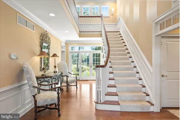 a large kitchen with kitchen island a sink table and chairs