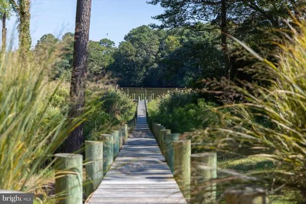 a dining room with furniture a chandelier and wooden floor