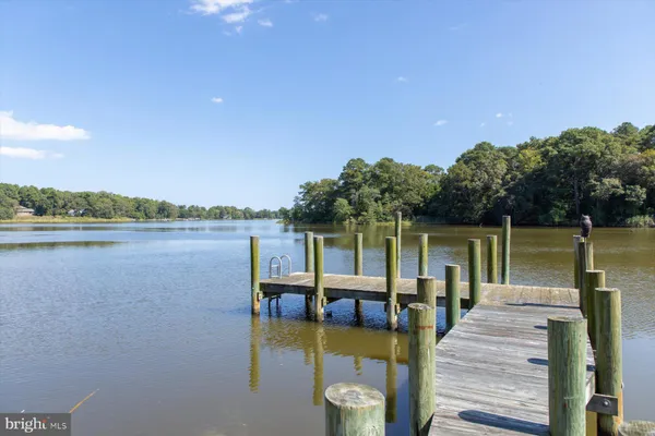 a spacious bedroom with a large bed and a flat tv screen