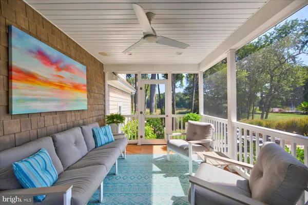 a spacious bedroom with a bed a dresser and a window