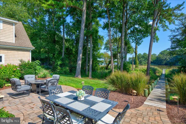 a spacious bathroom with sinks a large mirror and a bathtub next to a window