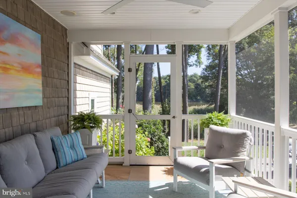 a spacious bedroom with a bed and glass walk in closet