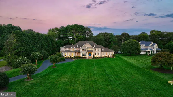 an aerial view of a house with a yard and trees