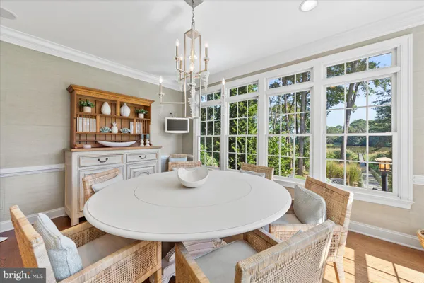 a view of a big house with a big yard and large trees