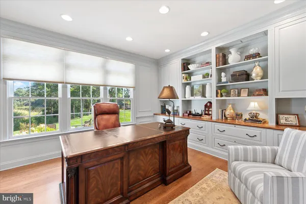 a front view of a house with a garden and trees