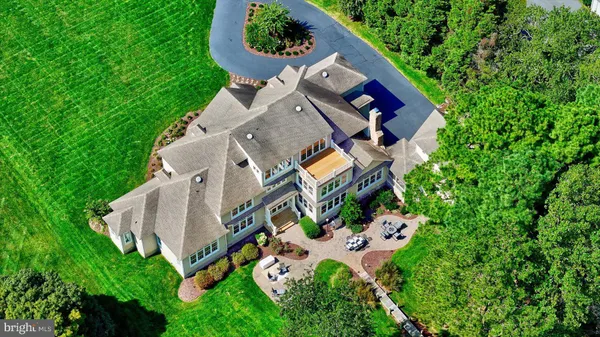 a aerial view of a house with a yard table and chairs