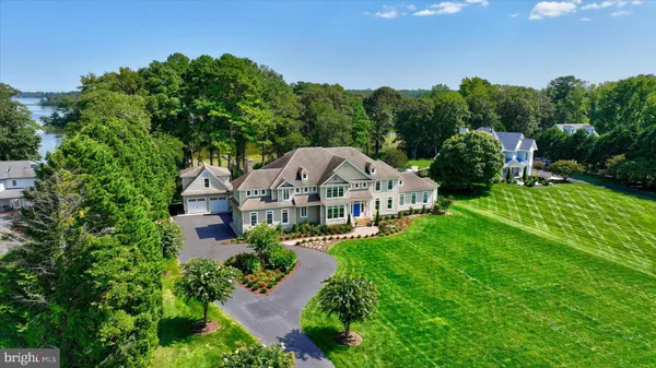a view of a lake with couches wooden floor and lake view