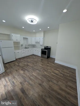a view of kitchen with cabinets and wooden floor