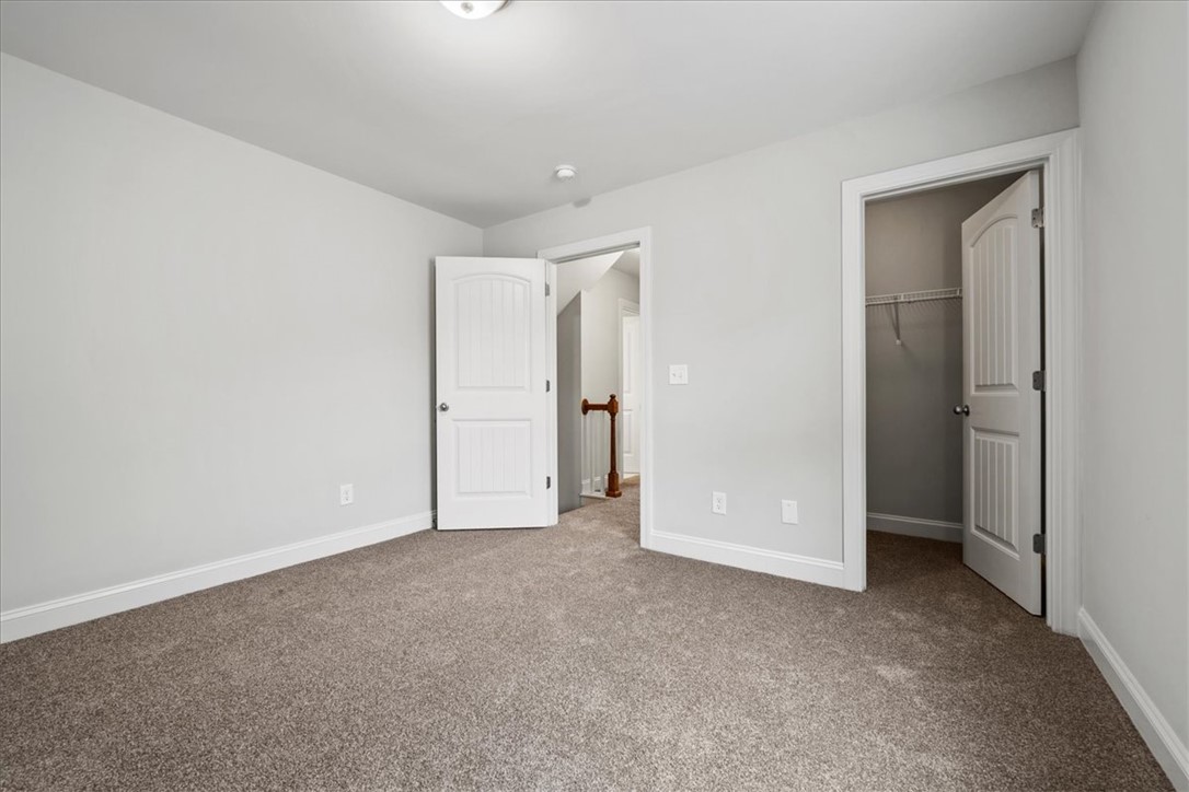 102 Ripplestone Way Anderson, SC 29621 - Photo 26 of 39 A well-lit bedroom offering a soft carpeted floor and convenient closet access.