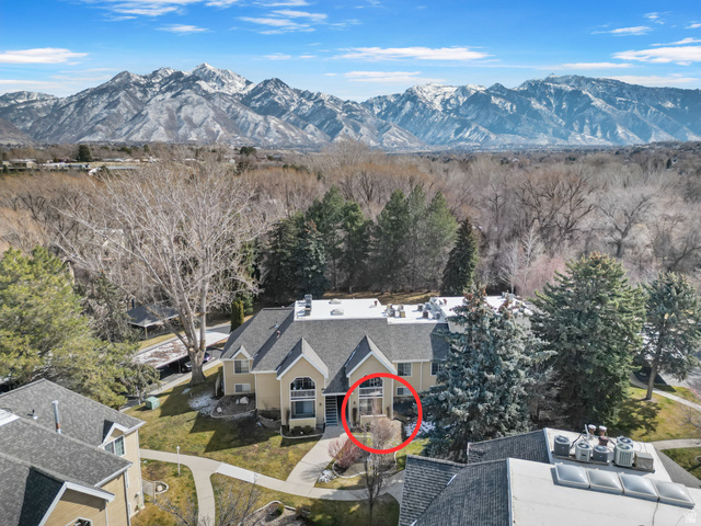 1228 East Waterside Cove, Unit 12 Midvale, UT 84047 - Photo 1 of 1 Drone / aerial view of a mountain backdrop