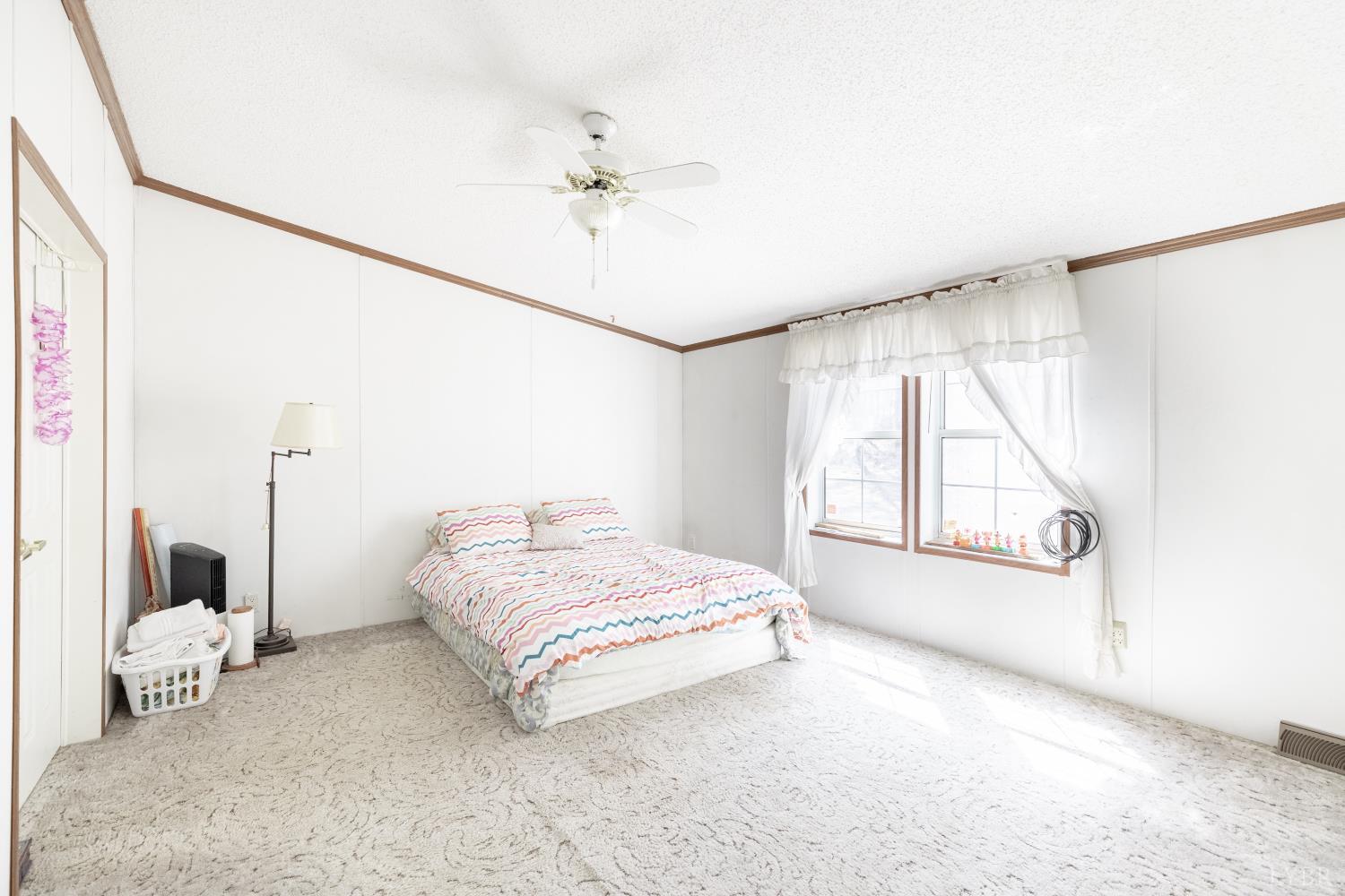 750 Price Lane Pamplin, VA 23958 - Photo 17 of 59 a spacious bedroom with a bed and a window