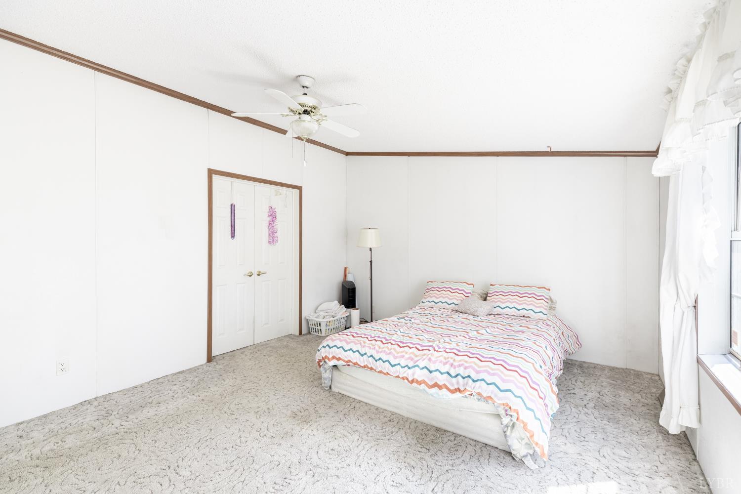 750 Price Lane Pamplin, VA 23958 - Photo 18 of 59 a bedroom with a bed and a chandelier