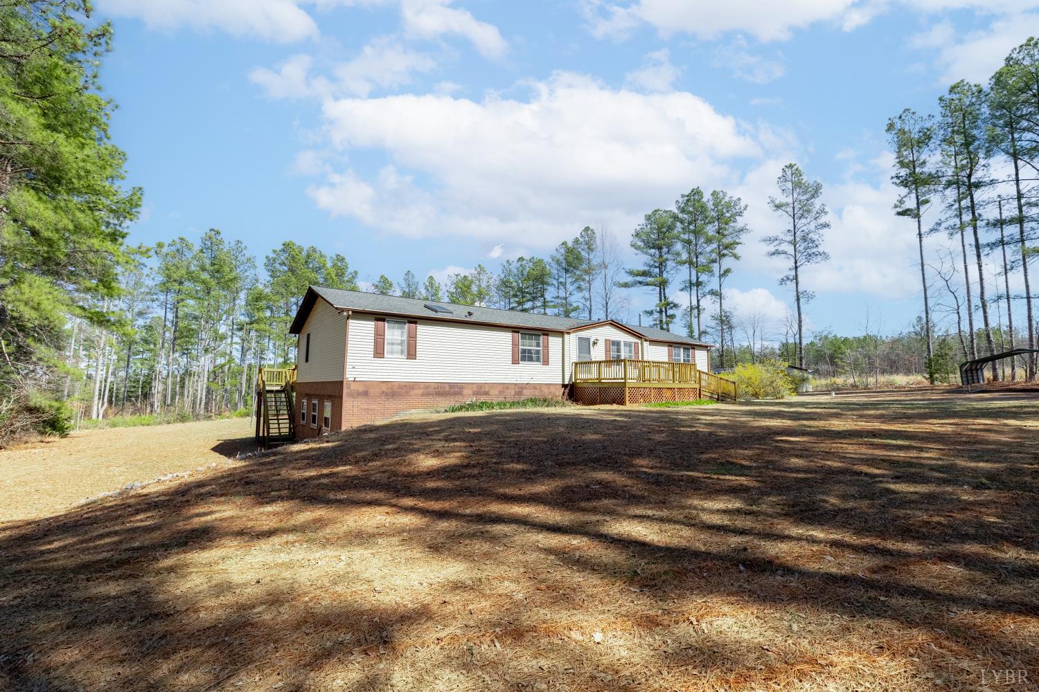 750 Price Lane Pamplin, VA 23958 - Photo 40 of 59 a front view of a house with a yard and lake view