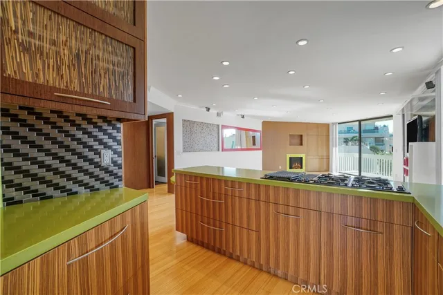 a kitchen with stainless steel appliances wooden cabinets and a stove top oven