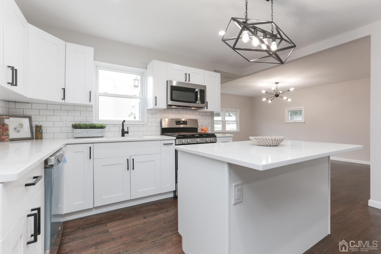 50 Hillcrest Road Colonia, NJ 07067 - Photo 3 of 24 a kitchen with a center island and cabinets