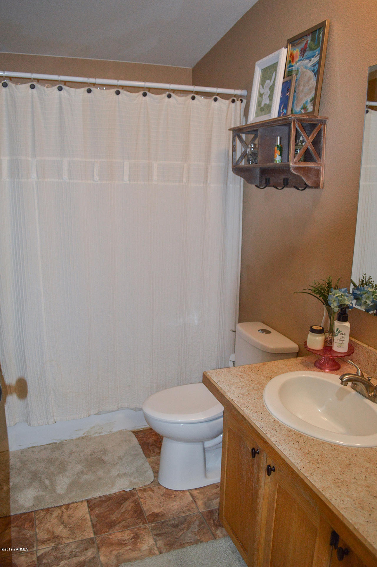 513 Burnham Road Yakima, WA 98908 - Photo 14 of 18 a bathroom with a granite countertop sink and a mirror