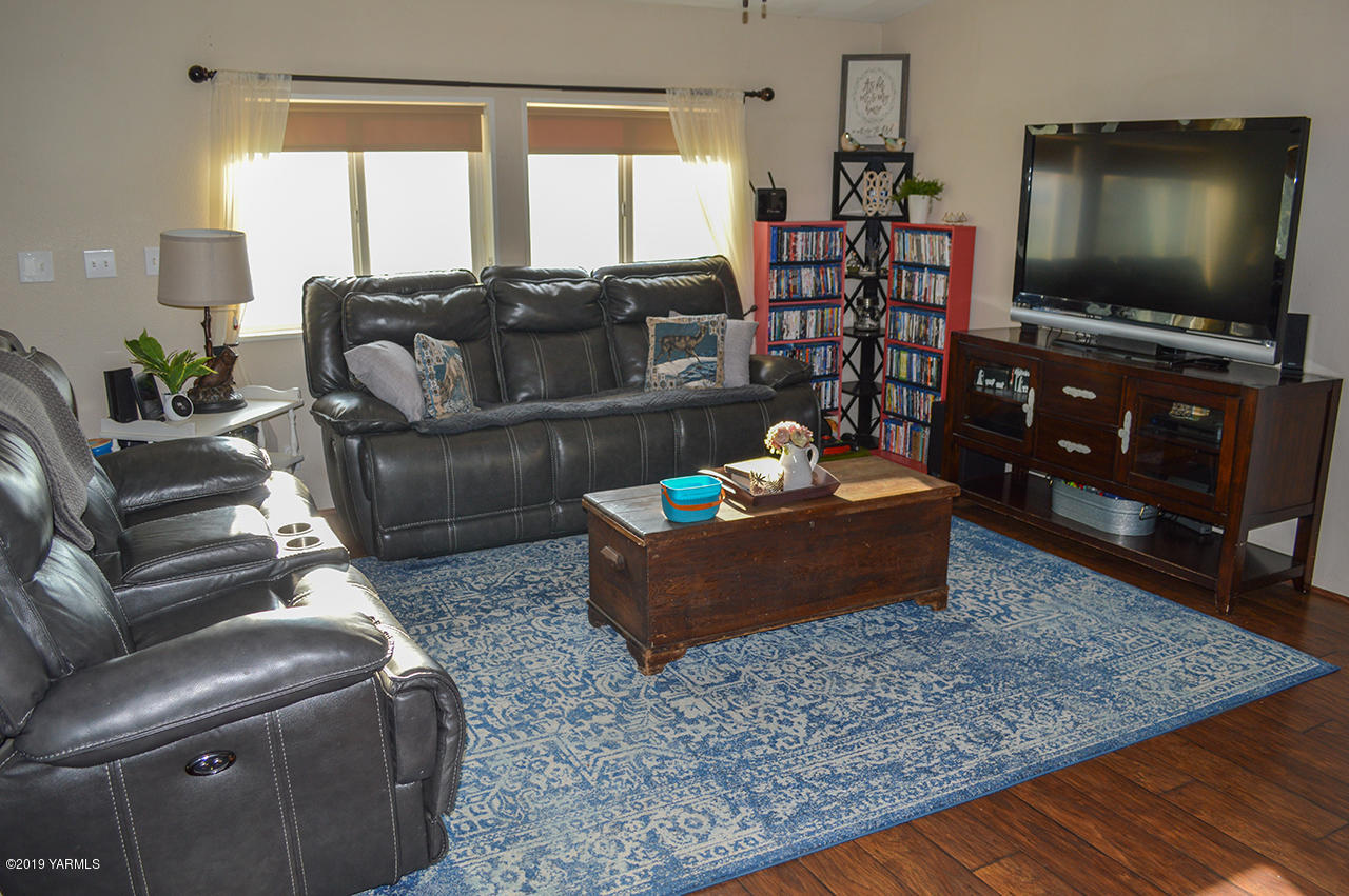 513 Burnham Road Yakima, WA 98908 - Photo 4 of 18 a living room with furniture and a flat screen tv