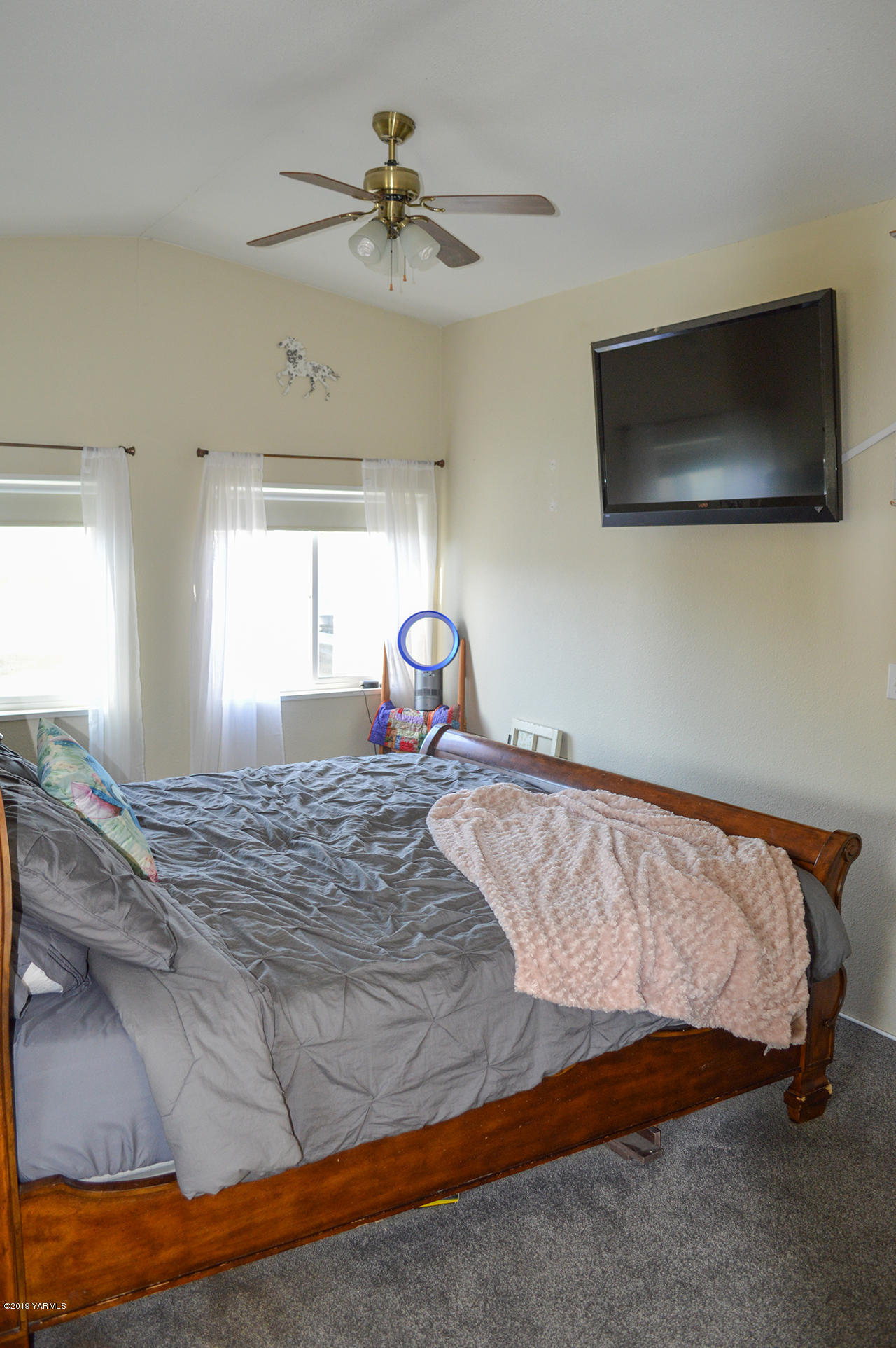 513 Burnham Road Yakima, WA 98908 - Photo 8 of 18 a bedroom with a bed and a flat screen tv