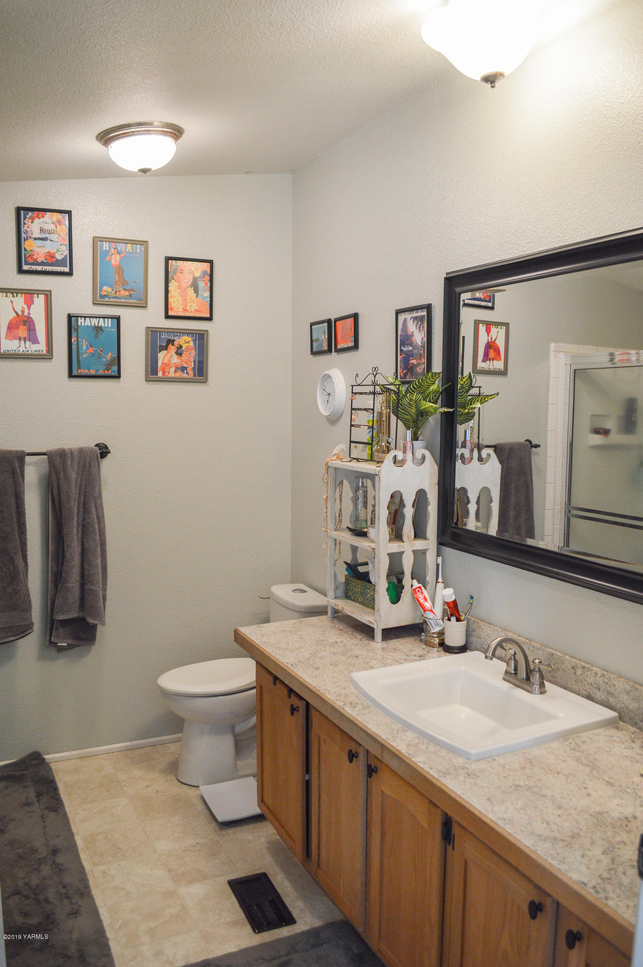513 Burnham Road Yakima, WA 98908 - Photo 10 of 18 a bathroom with a granite countertop sink mirror vanity and toilet