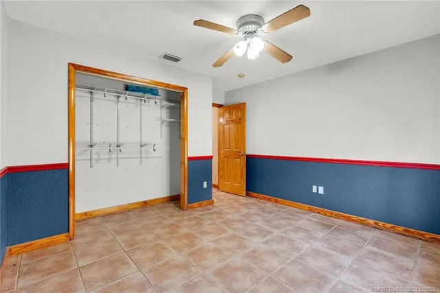 a kitchen with stainless steel appliances granite countertop a table chairs refrigerator and microwave