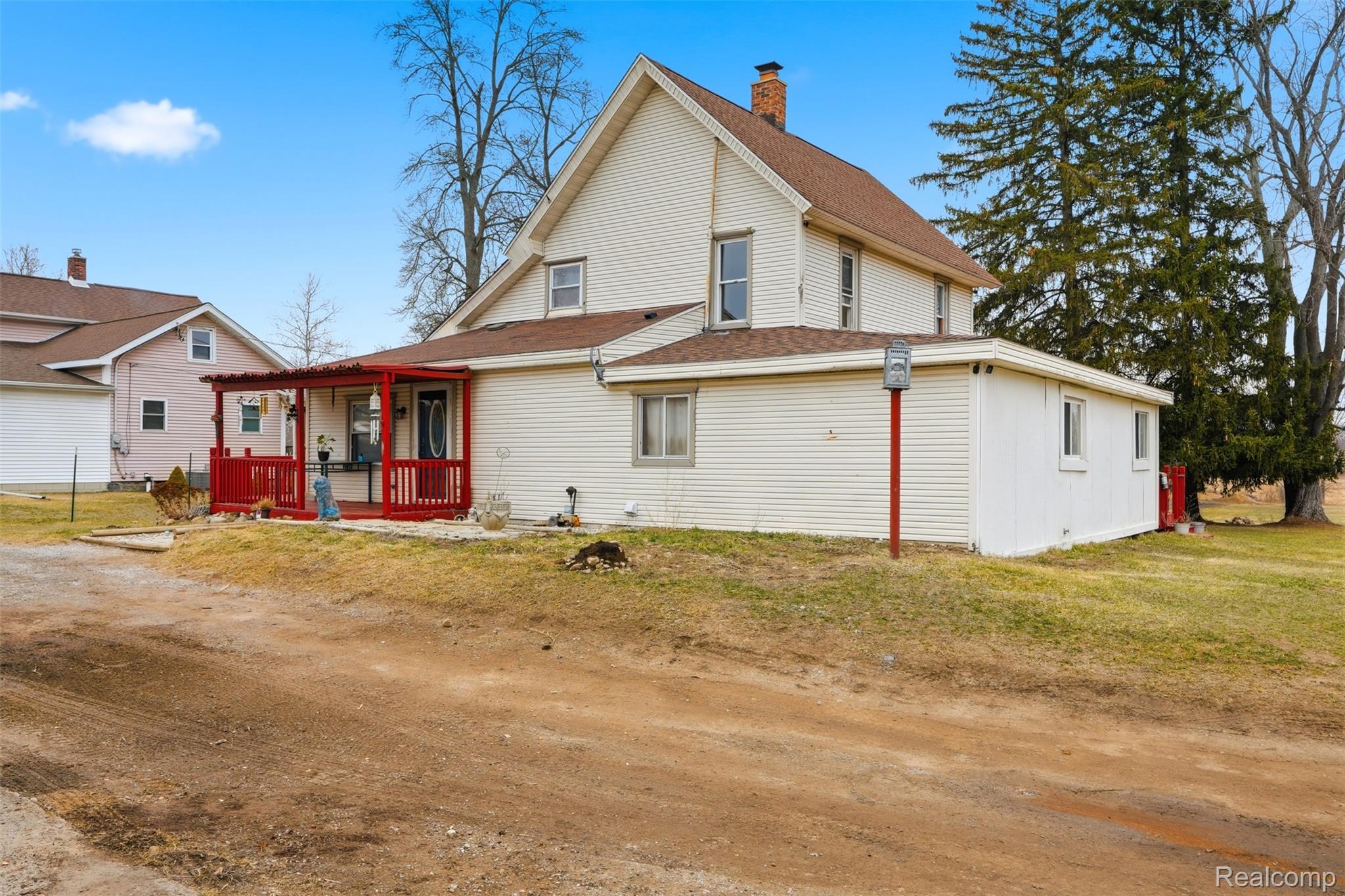 8732 Kinch Road Jackson, MI 49201 - Photo 6 of 39 Rear view of house with a wooden deck, a lawn, and a chimney