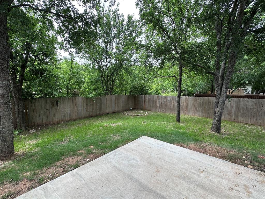 1212 Bowman Ridge Road Stephenville, TX 76401 - Photo 2 of 23 a view of a yard with a tree