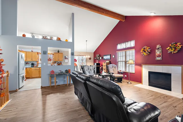 a living room with furniture a flat screen tv and a fireplace