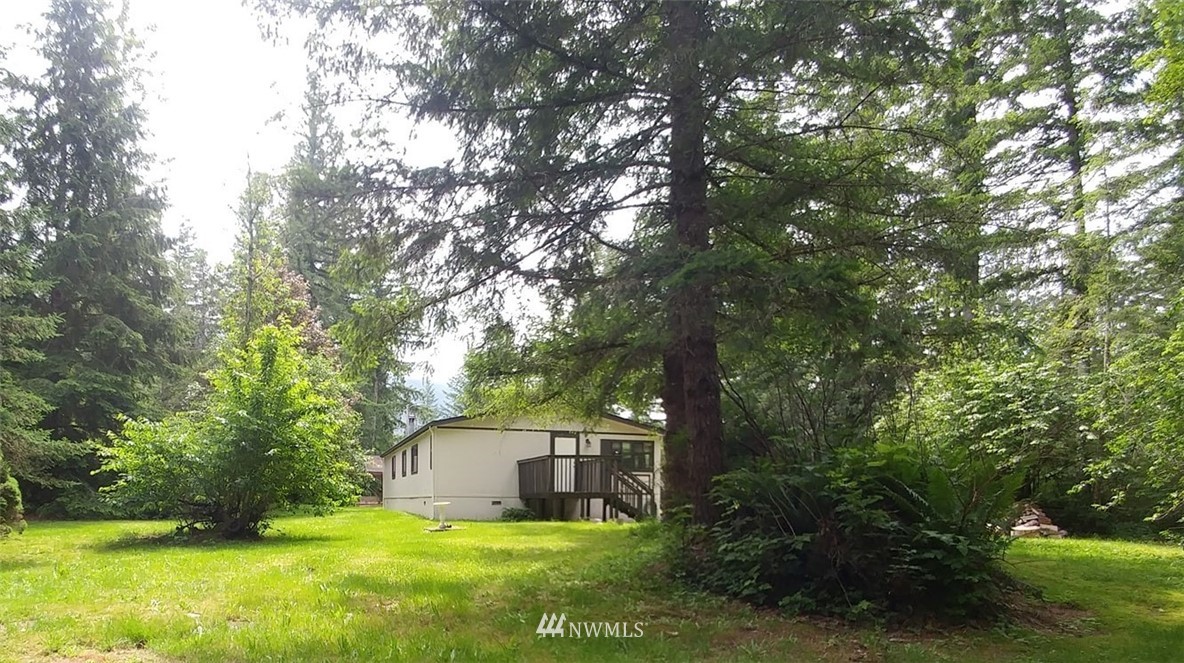40805 Dorman Road Gold Bar, WA 98251 - Photo 22 of 25 a view of a house with a yard deck and a tree