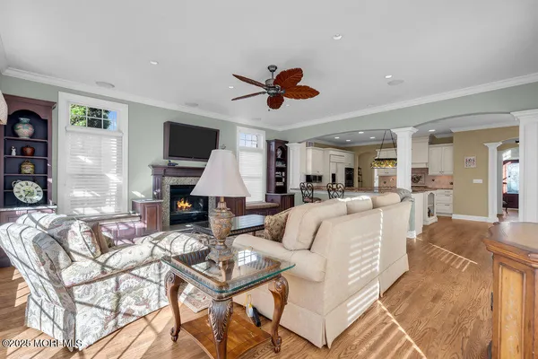 a living room with furniture a fireplace and a flat screen tv