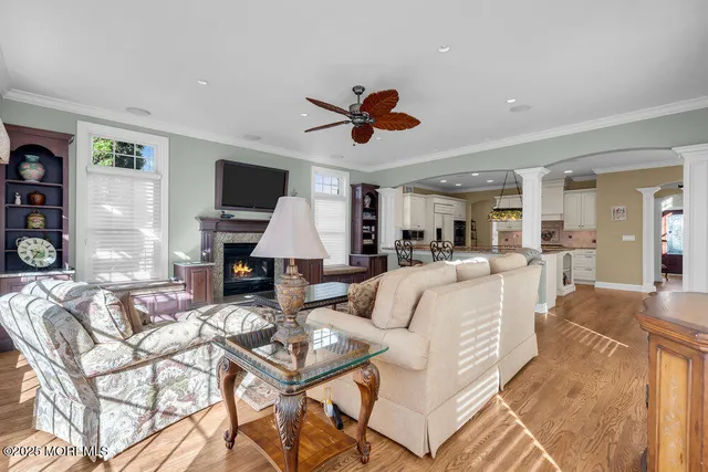 a living room with furniture a fireplace and a flat screen tv