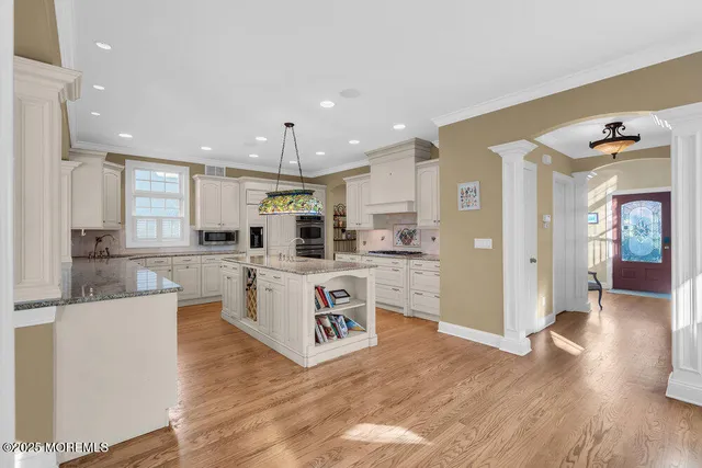 a kitchen with white cabinets and refrigerator