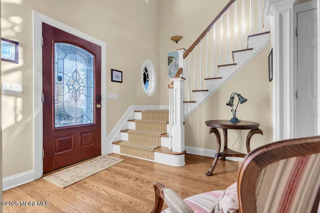 a view of entryway livingroom and hall with wooden floor